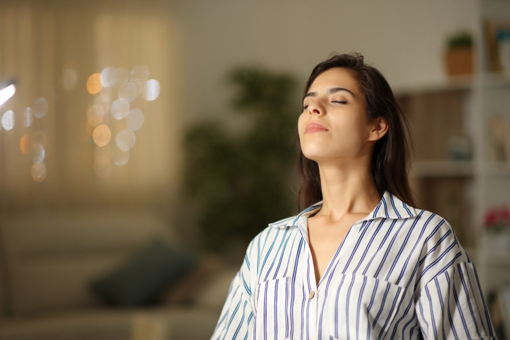 Satisfied,Woman,Breathing,Sitting,At,Home,In,The,Night